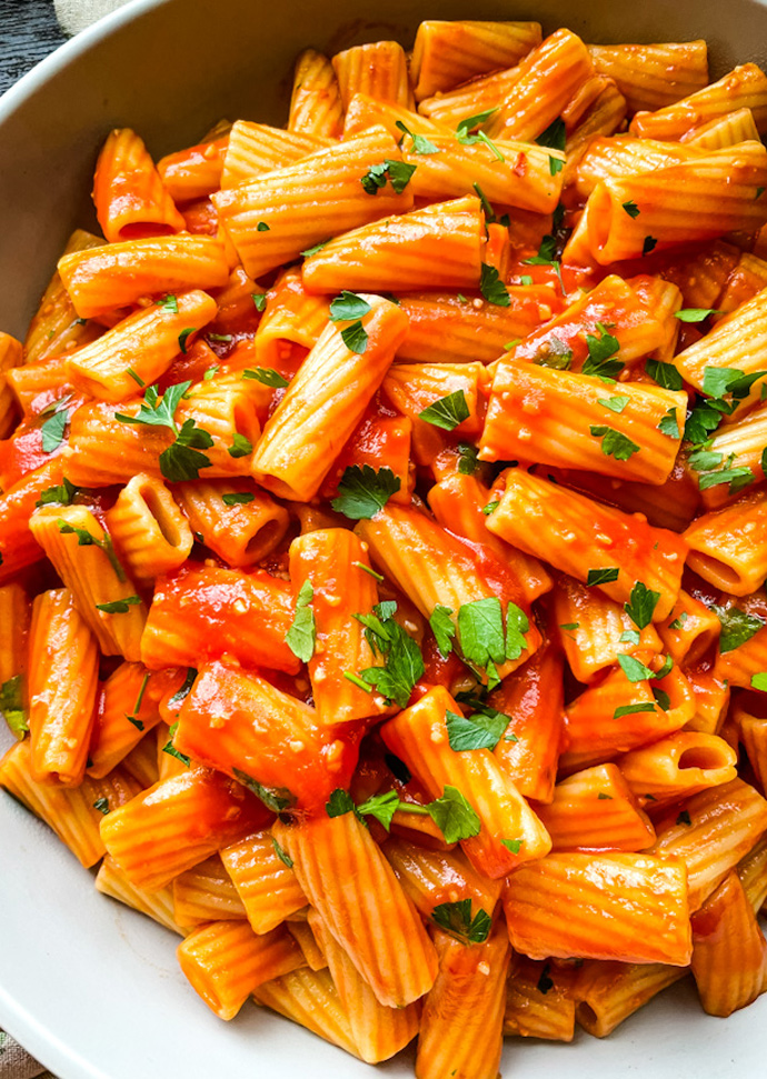 vegan pasta all arrabbiata topped with chopped parsley.