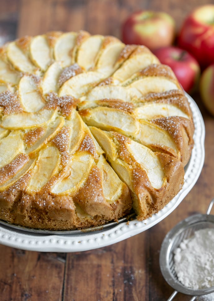 torta di mele (apple cake) topped with sliced apples and confectioner's sugar.