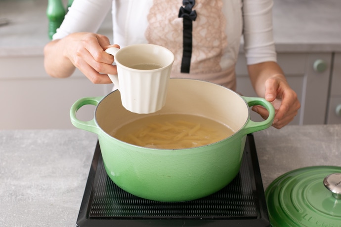 how to cook pasta step 5, remove 1 cup of pasta water from the pot.