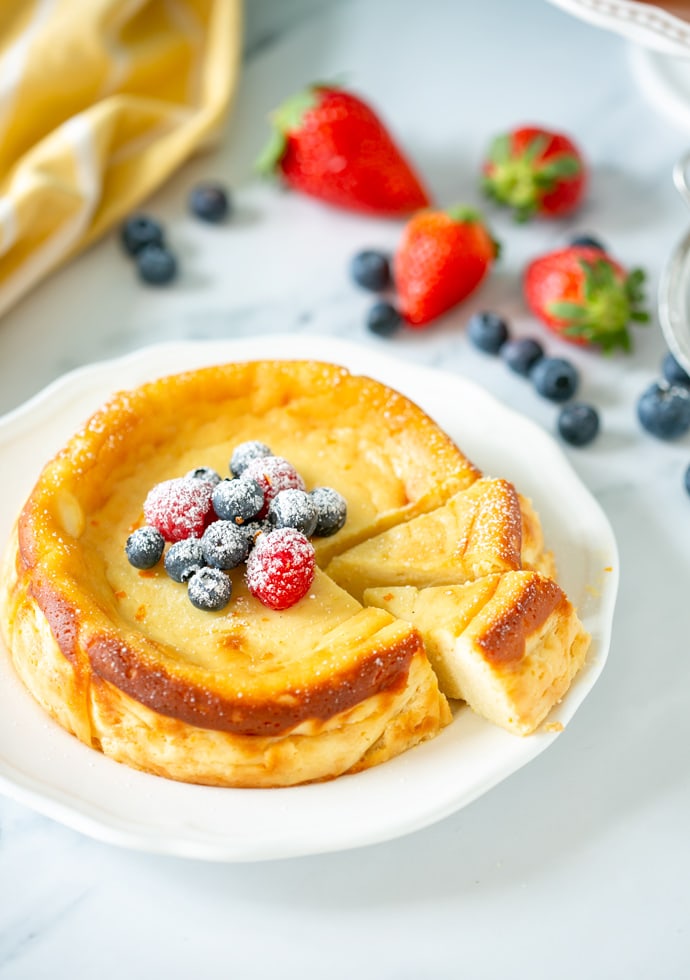 Italian ricotta cheesecake topped with fresh berries and confectioner's sugar.