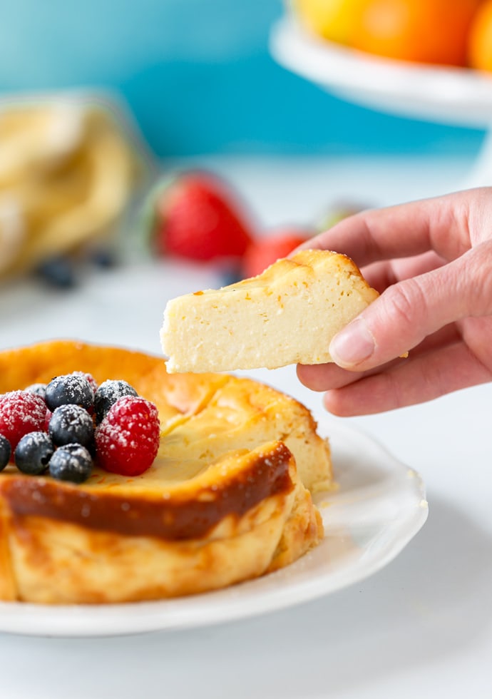 Italian ricotta cheesecake topped with fresh berries and confectioner's sugar.