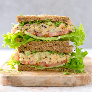 no tuna chickpea salad sandwich on a chopping board.