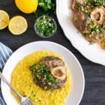 ossobuco alla milanese served over a bed of saffron risotto, and topped with gremolata.Image with text for Pinterest.