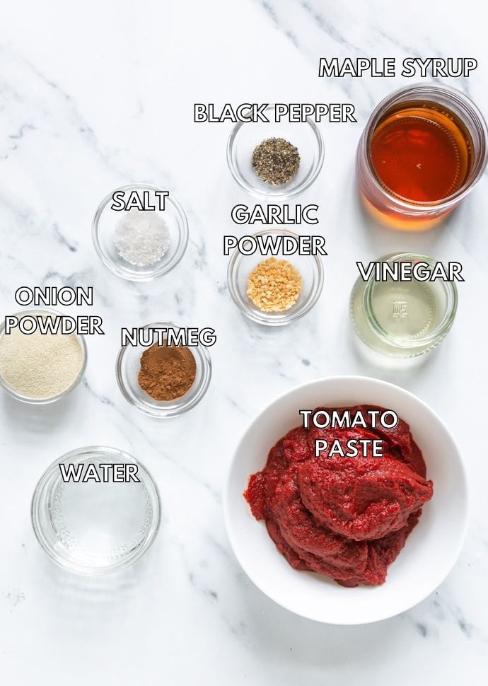 homemade ketchup ingredients: tomato paste, maple syrup, vinegar, water, nutmeg, onion powder, garlic powder, salt, pepper.