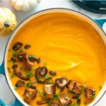 creamy vegan pumpkin soup and white beans topped with croutons and sauteed mushrooms. Image with text for Pinterest.