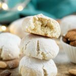 italian amaretto cookies coated in powdered sugar, image withy text for Pinterest.