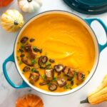 creamy vegan pumpkin soup with white beans, topped with croutons and sauteed shiitake mushrooms.