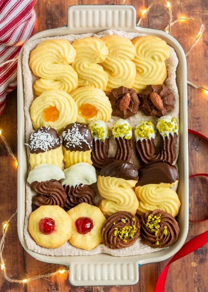 christmas italian butter cookies with various toppings and decorations.