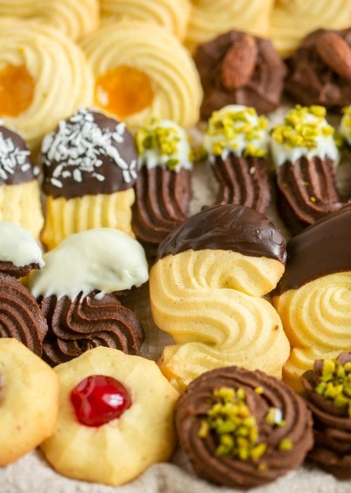 italian christmas butter cookies with various toppings.