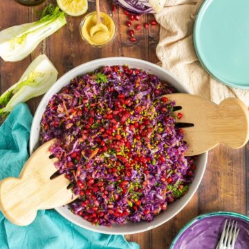 winter slaw topped with pistachio nuts and pomegranate seeds.