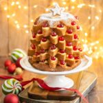 Pandoro Italian Christmas cake filled with pastry cream and topped with candied cherries.