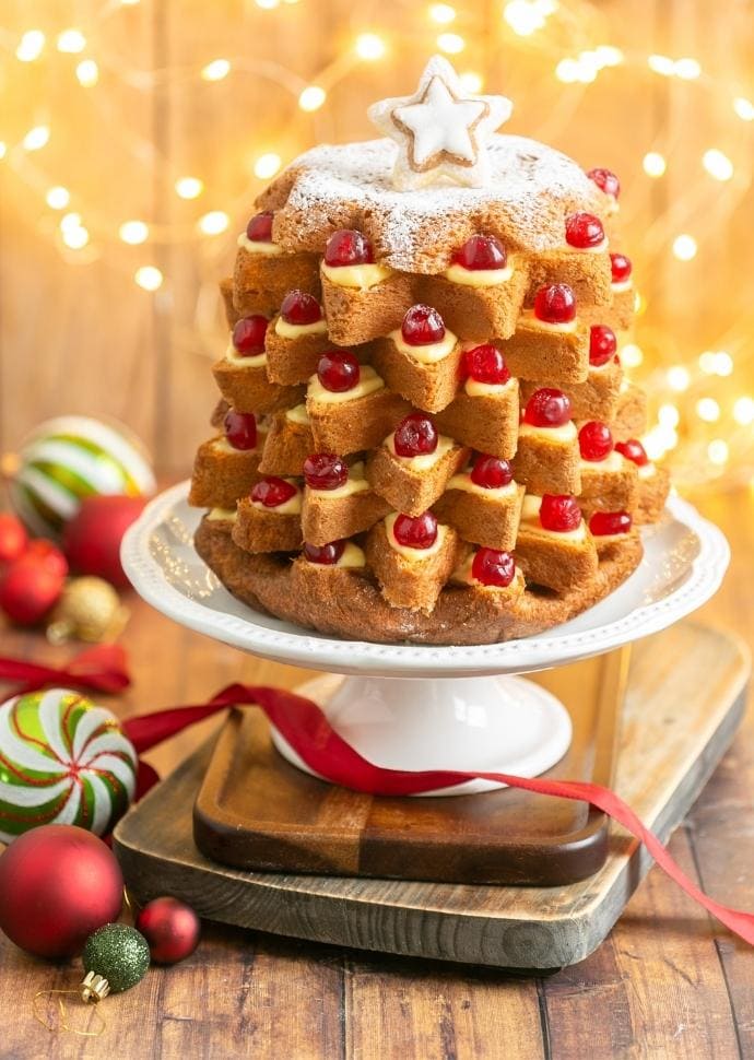 Italian christmas cake filled with pastry cream and topped with candied cherries and powdered sugar.
