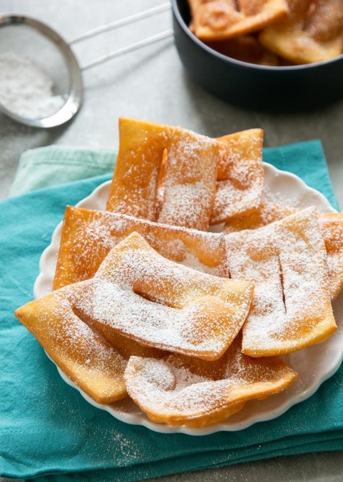 chiacchiere dusted with powdered sugar.