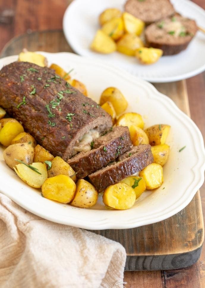 polpettone stuffed with cheese served with roasted potatoes.