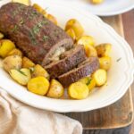 italian meatloaf stuffed with cheese served with roasted potatoes.