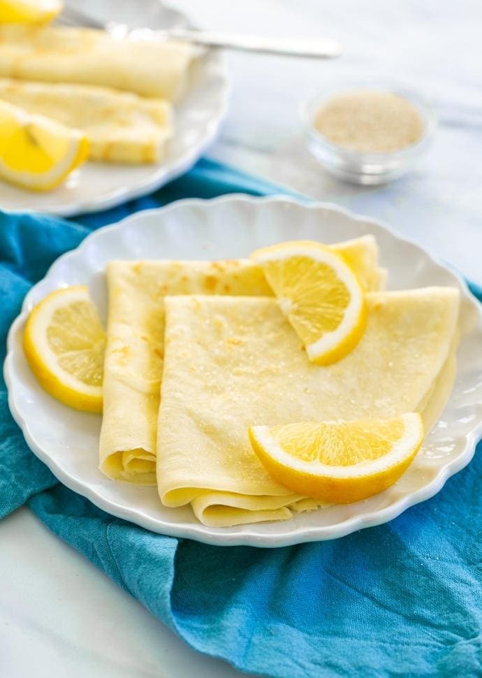 British pancakes served with lemon wedges and sugar.