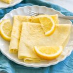 Traditional British Pancakes served with lemon wedges and caster sugar.