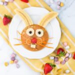 Easter bunny pancake decorated with bananas, strawberry, blueberries and carrot.