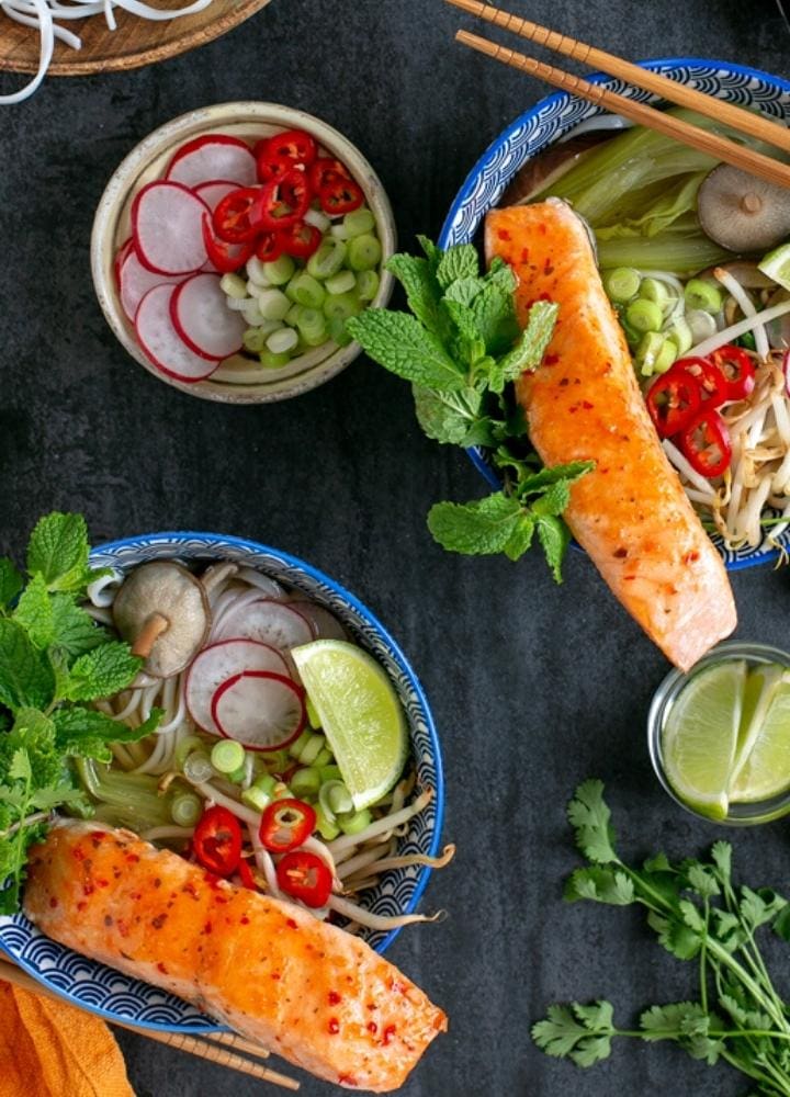 salmon pho into bowls.