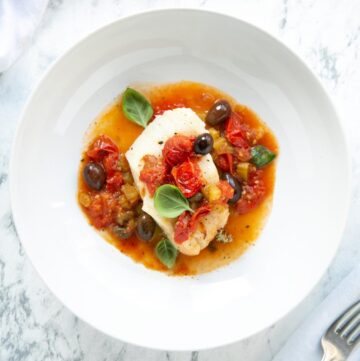 cod puttanesca in tomato sauce, olives and capers.