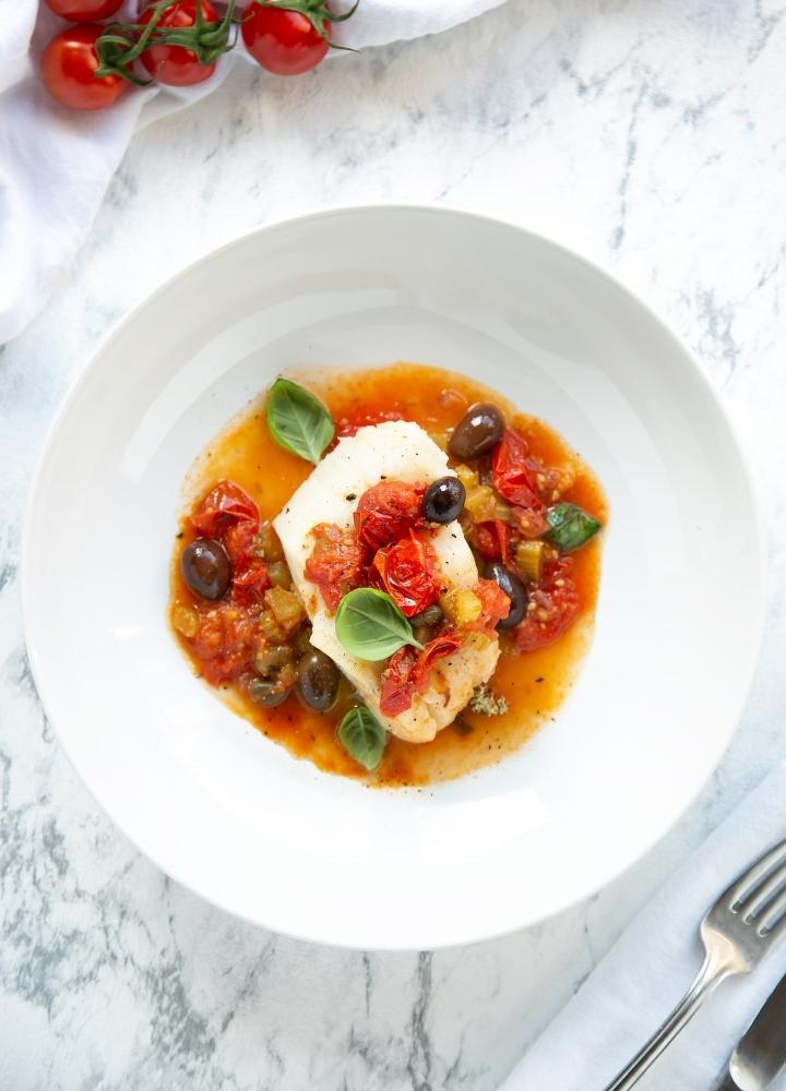 cod puttanesca with tomato sauce, olives and capers.