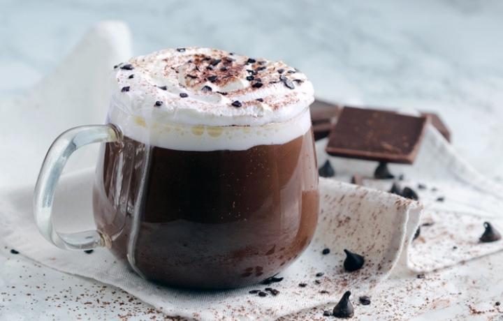 thick hot chocolate topped with whipped cream.
