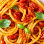 bucatini with pomodoro sauce. Image with text for Pinterest.