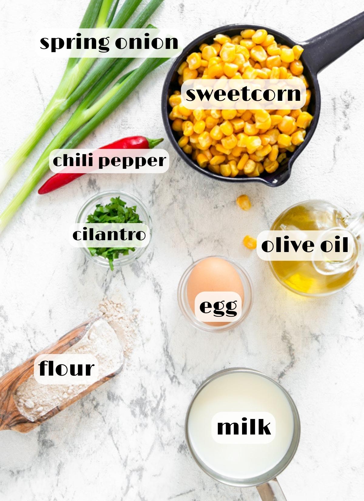 sweetcorn fritters ingredients: sweetcorn, spring onion, cilantro, chili, oil, egg, flour, milk.