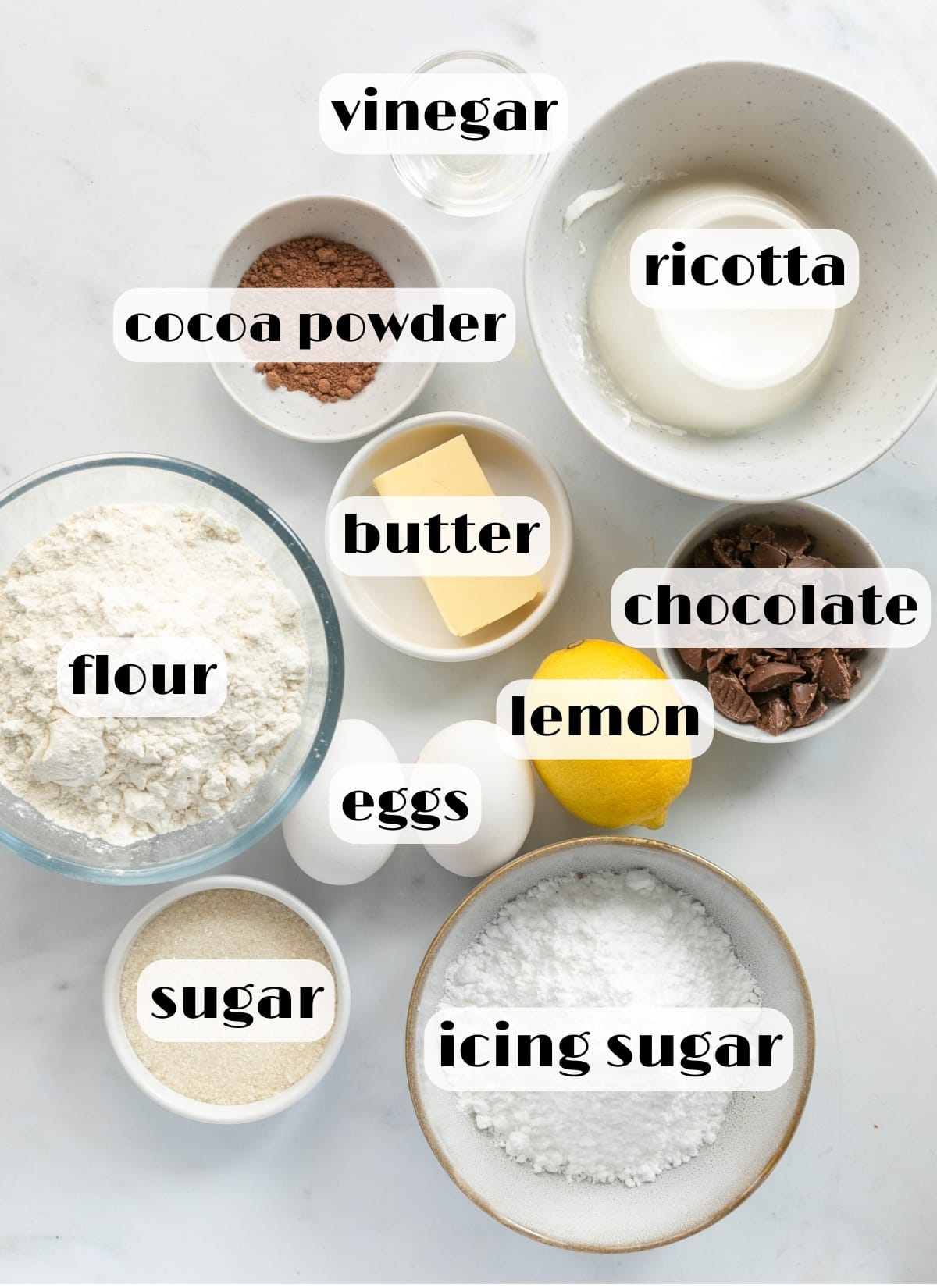 Chocolate cannoli ingredients: ricotta, vinegar, cocoa powder, butter, chocolate, flour, lemon, eggs, sugar, marsala wine, icing sugar.