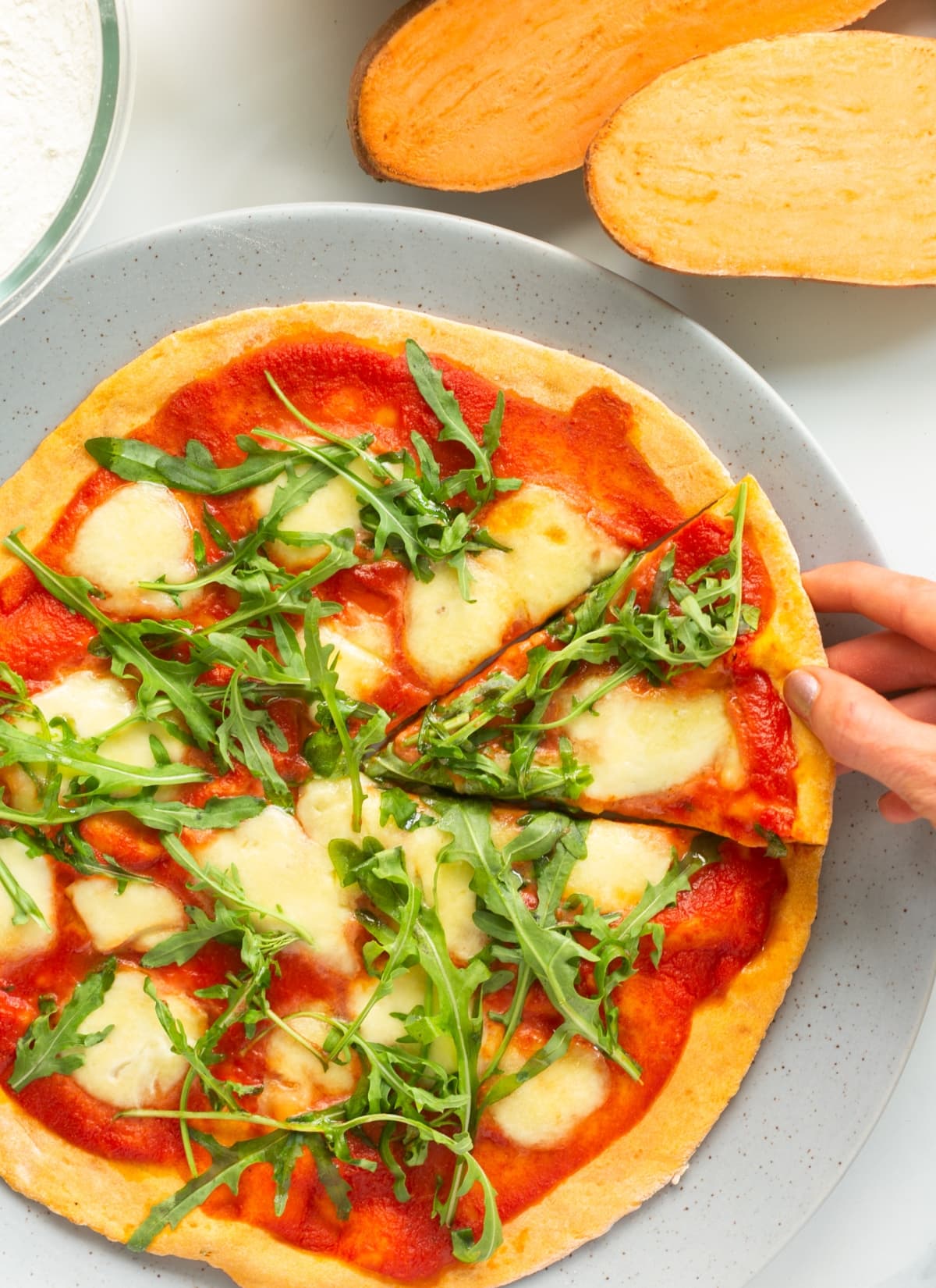 sweet potato crust pizza, topped with marinara sauce, mozzarella and arugula.