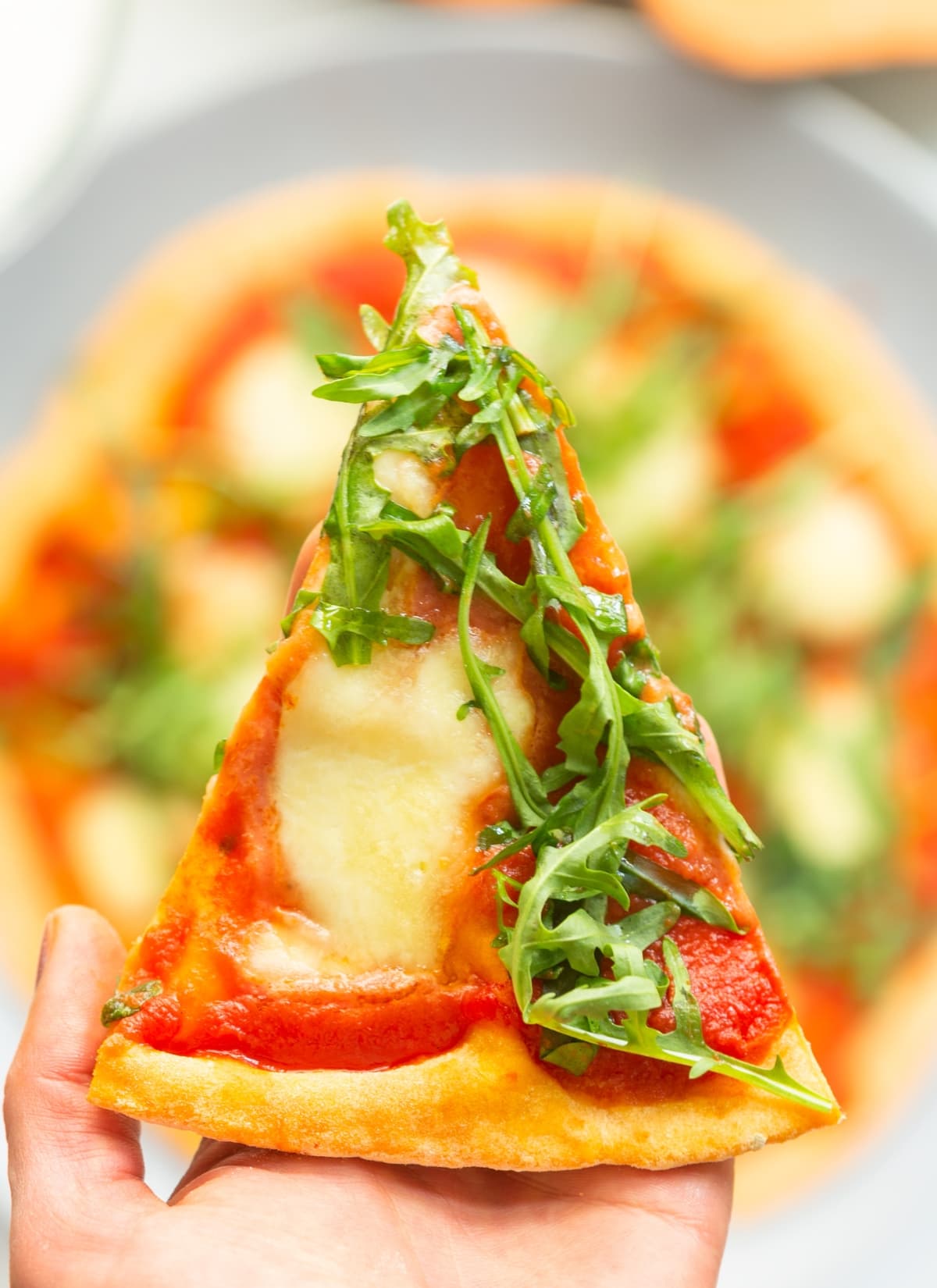 sweet potato pizza crust, topped with pizza sauce, mozzarella and arugula.