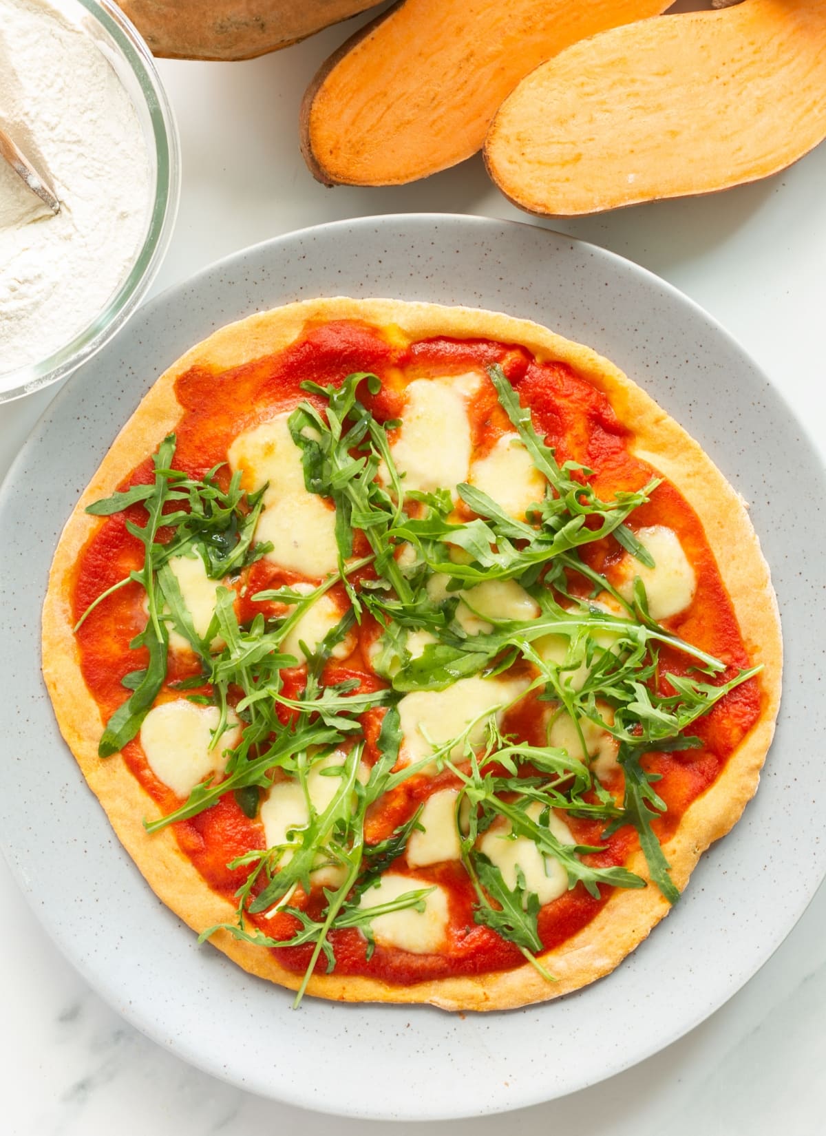 pizza with sweet potato crust, pizza sauce, mozzarella, arugula.