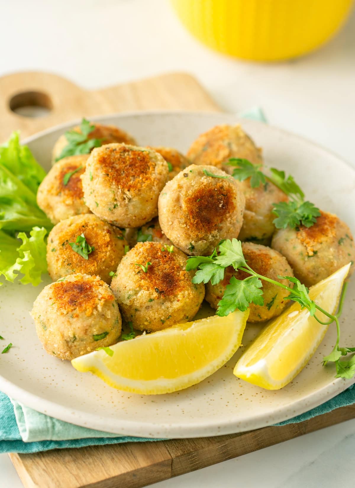 tuna fish meatballs, served with lemon wedges on the side.