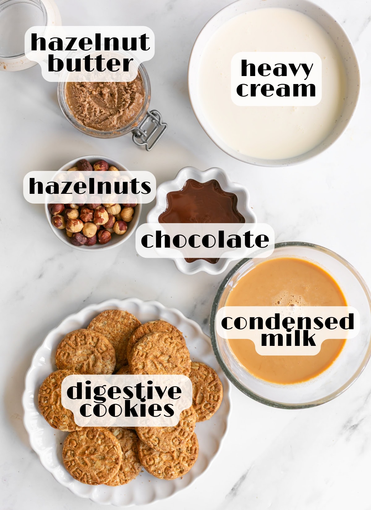 hazelnut gelato cake ingredients: condensed milk, heavy cream, hazelnut butter, roasted hazelnuts, digestive cookies, melted chocolate.