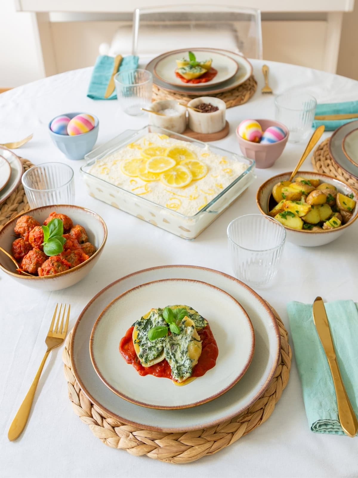 stuffed pasta shells with ricotta and spinach, served with meatballs and roasted potatoes on the side.