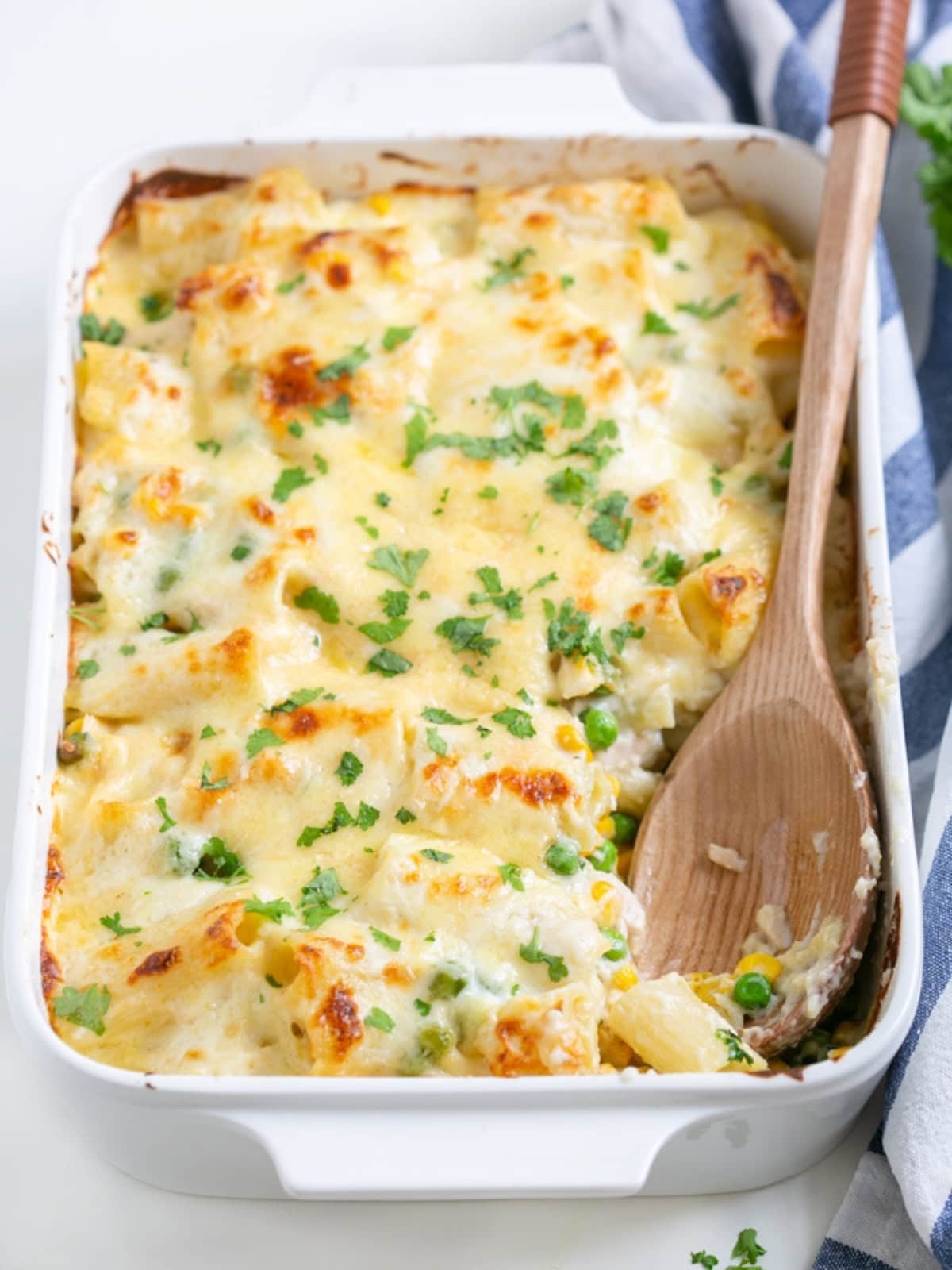 tuna pasta bake topped with white sauce.